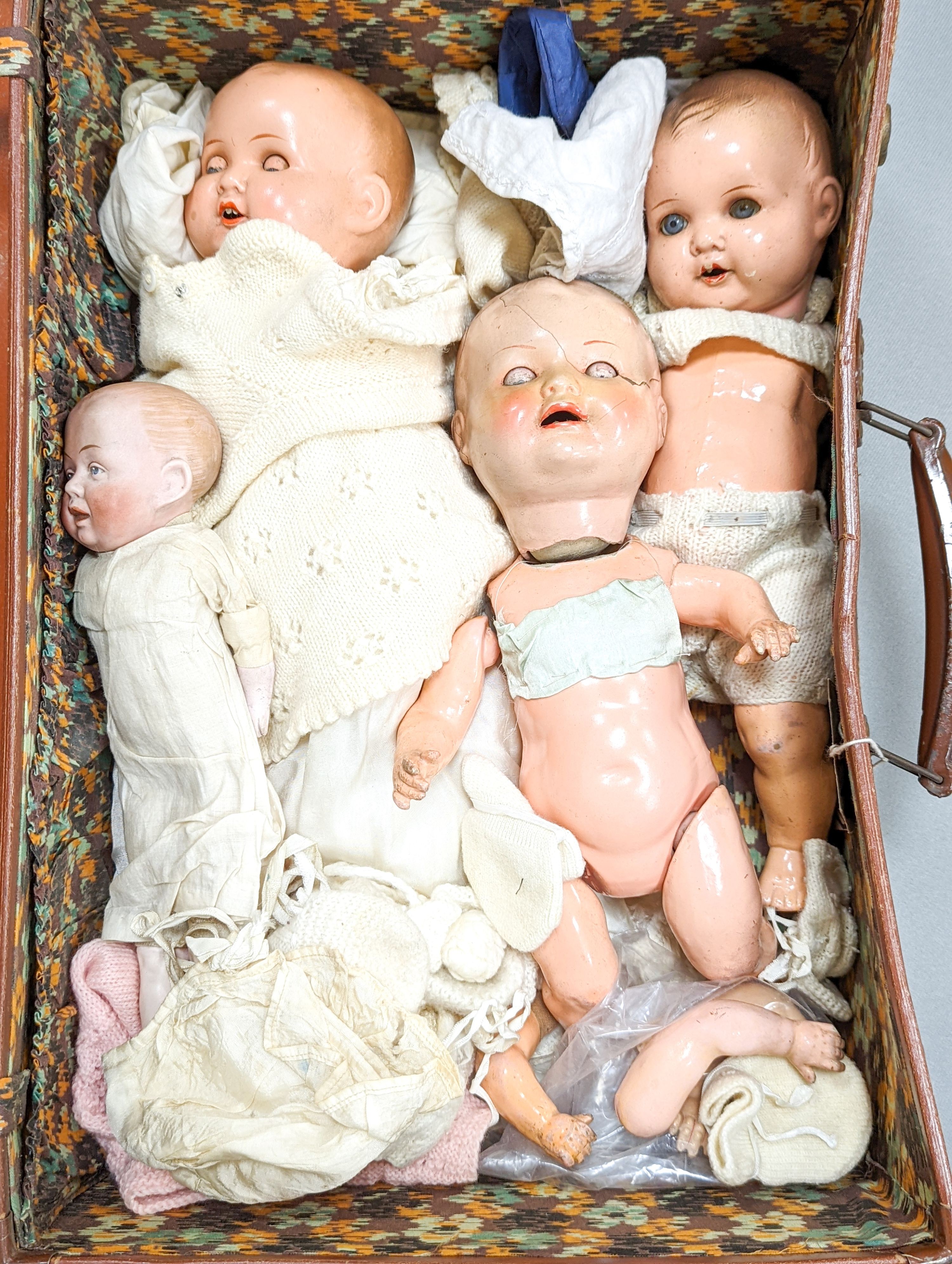 A 19th century German bisque-headed doll and three composition dolls
